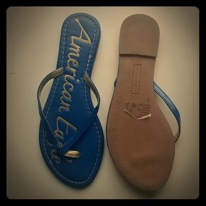 Blue and gold American Eagle flip flops